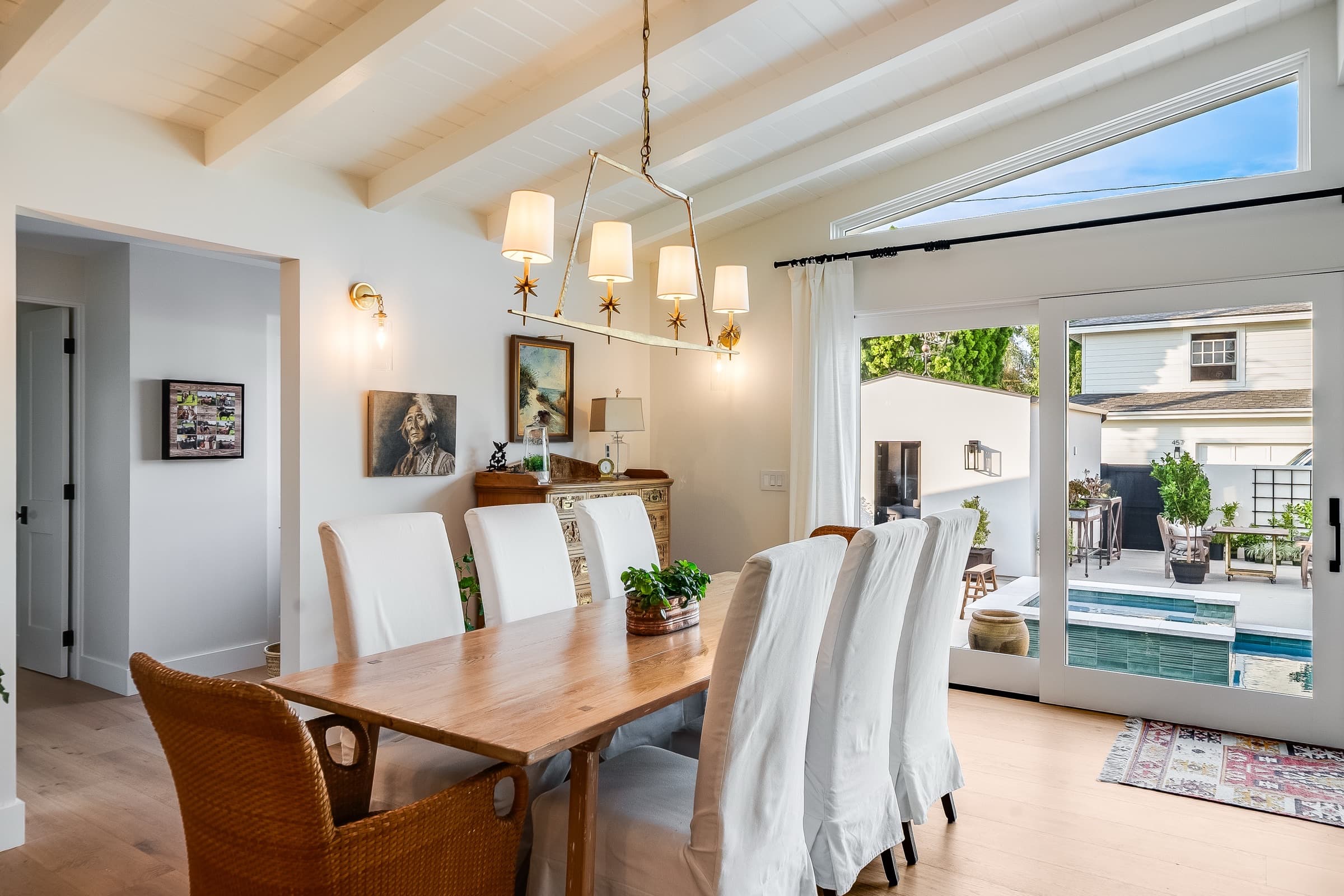 Finished dining room opening to a pool terrace